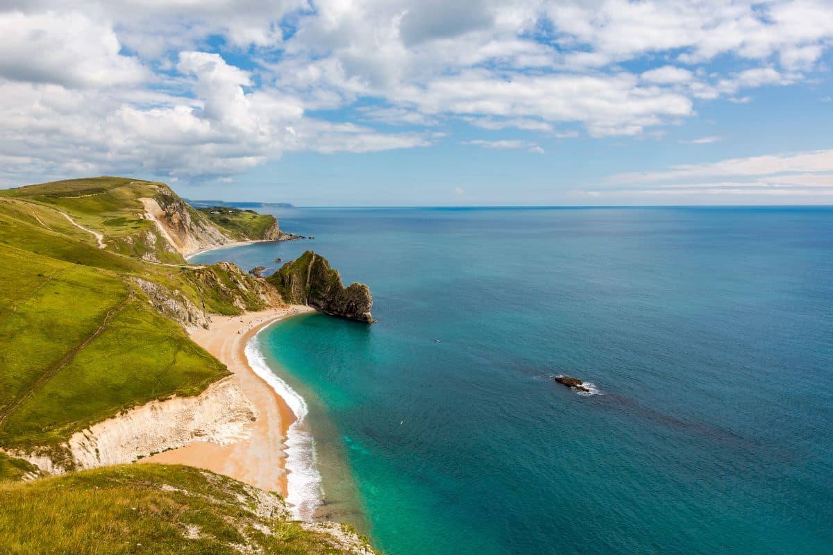 A view towards the famous Durdle Door on the Jurassic Coast in England, UK on a sunny day