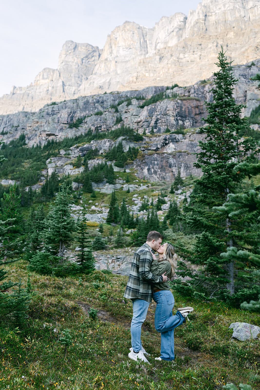 Banff proposal photographer documenting a heartfelt proposal on a mountain overlook