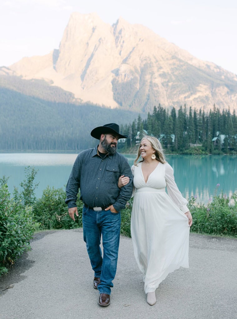 Couple eloping in Yoho National Park with emerald green lake, towering Rocky Mountain peaks, and lush pine forest in British Columbia.