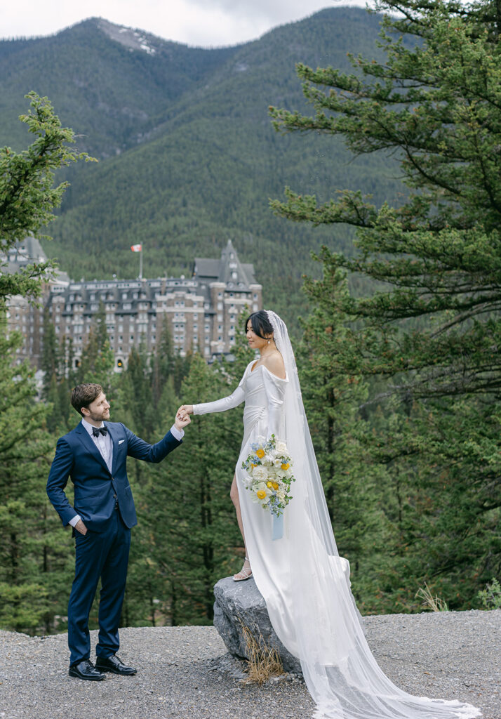 Fairmont Banff Springs wedding ceremony with couple exchanging vows in front of the iconic castle hotel