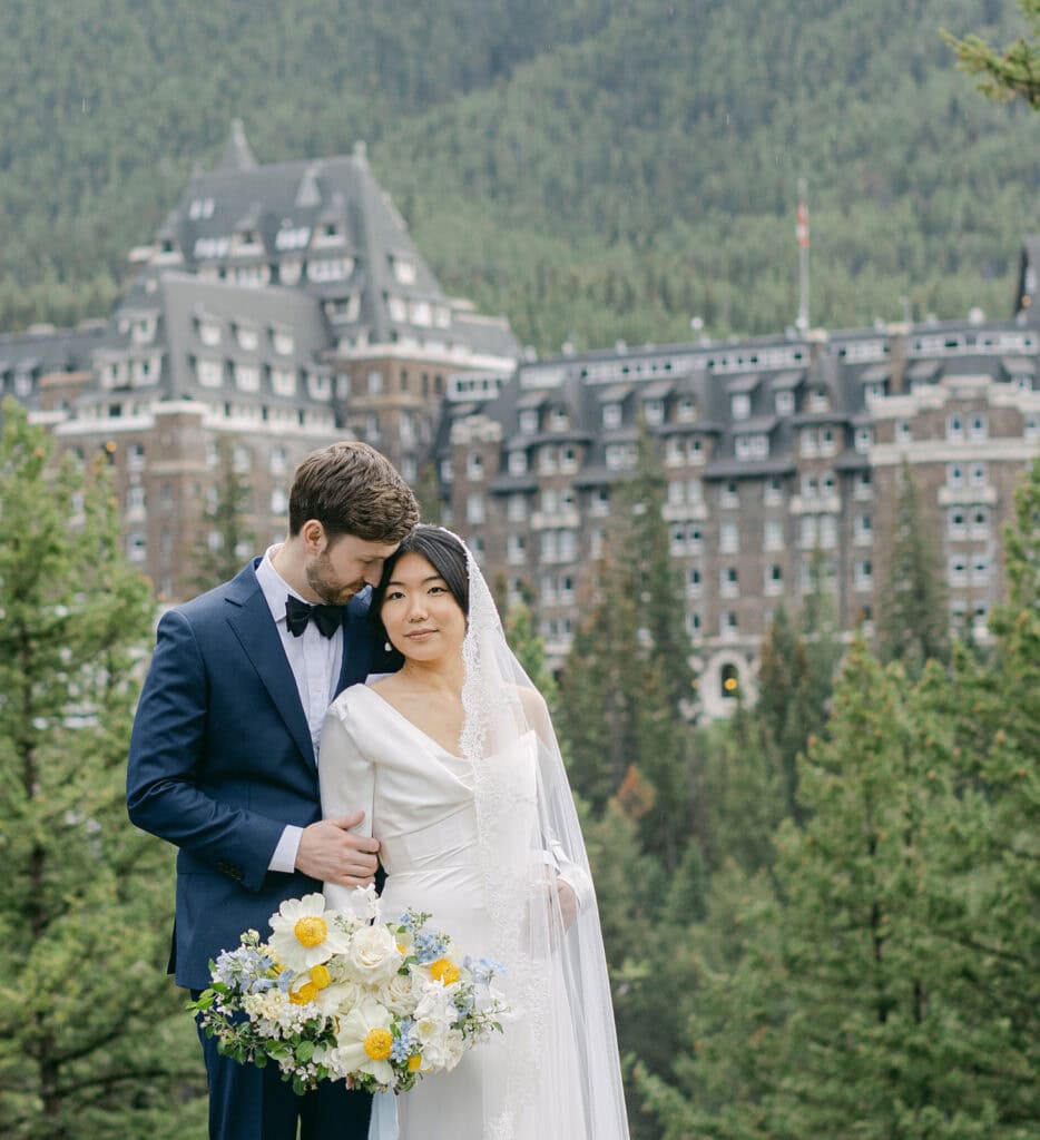 Banff Springs elopement with couple exchanging vows in front of the iconic castle hotel in Banff