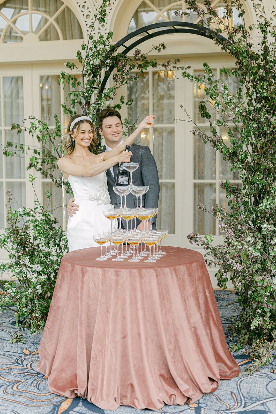 Banff wedding photographer capturing a couple celebrating their wedding with a champagne pop