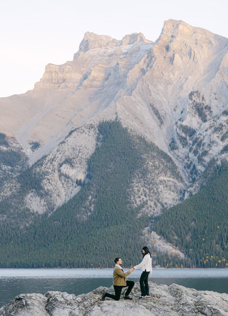 Romantic Banff proposal at sunset in Banff National Park with mountain backdrop