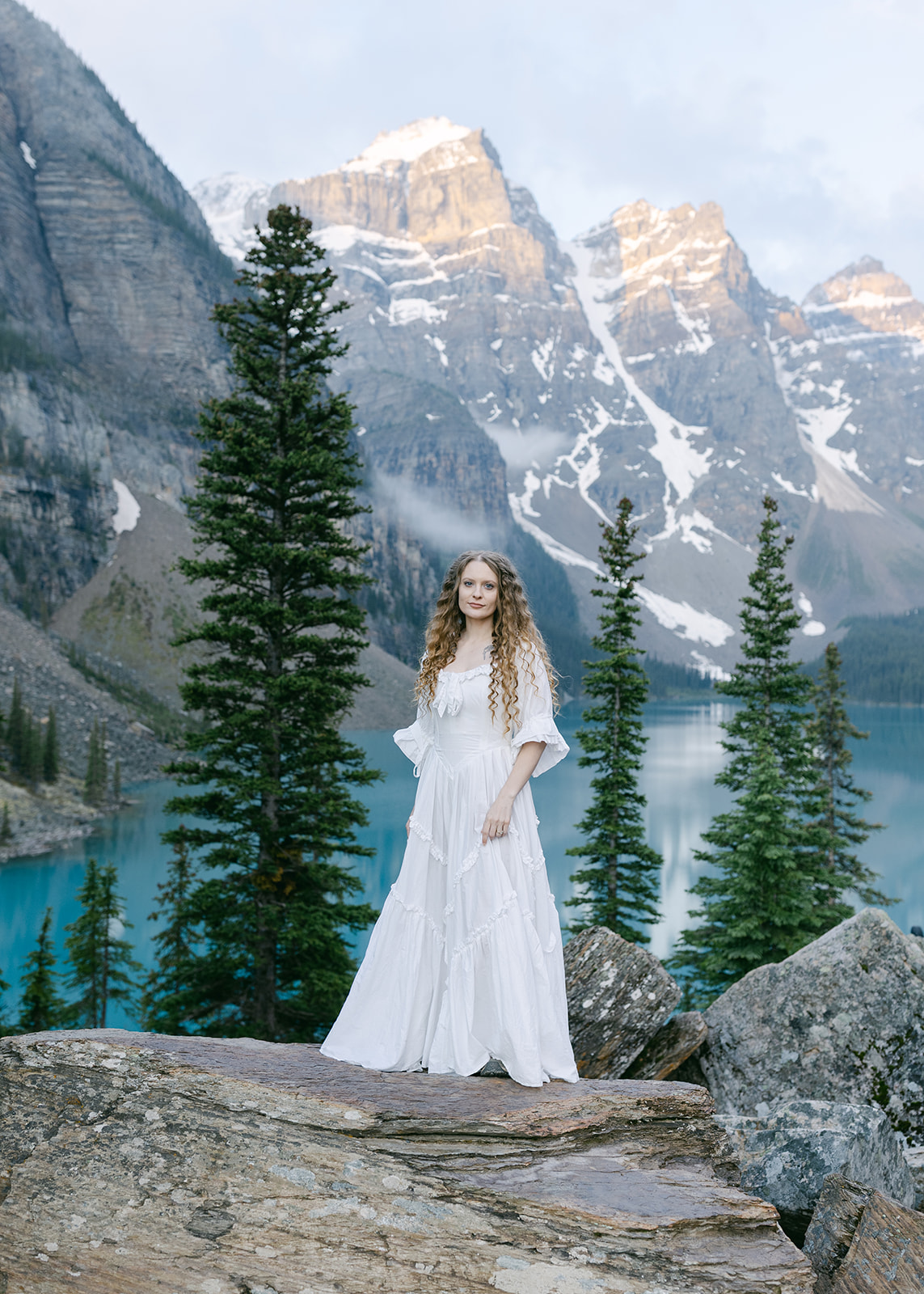 Romantic Alberta elopement with mountain views and alpine lake backdrop