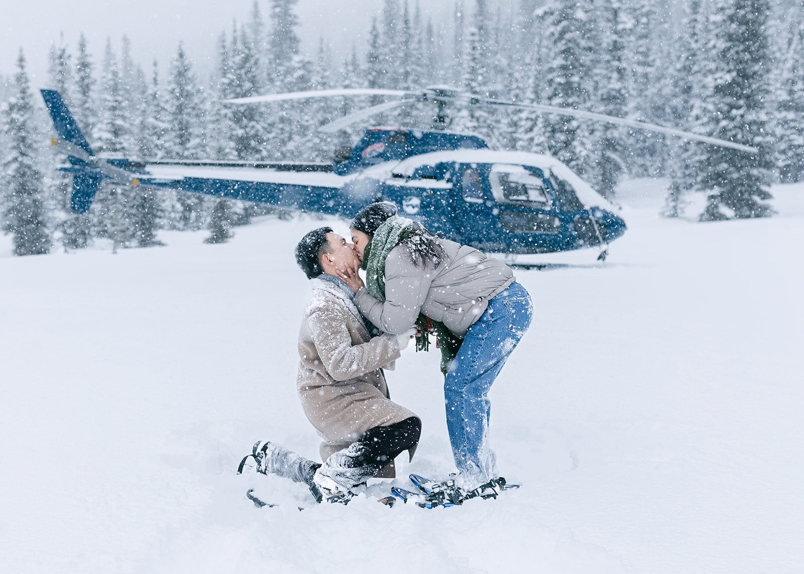 Romantic winter helicopter proposal in Banff with heavy snowfall and obscured mountain views