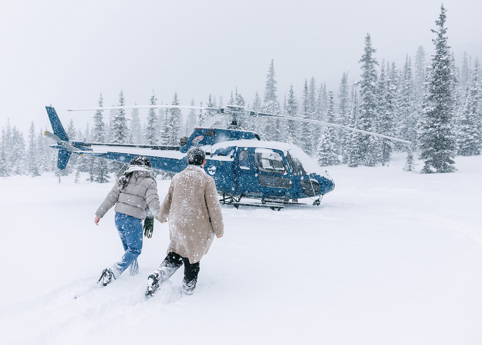 Intimate Banff helicopter proposal in a winter snowstorm with the Rockies hidden in whiteout conditions