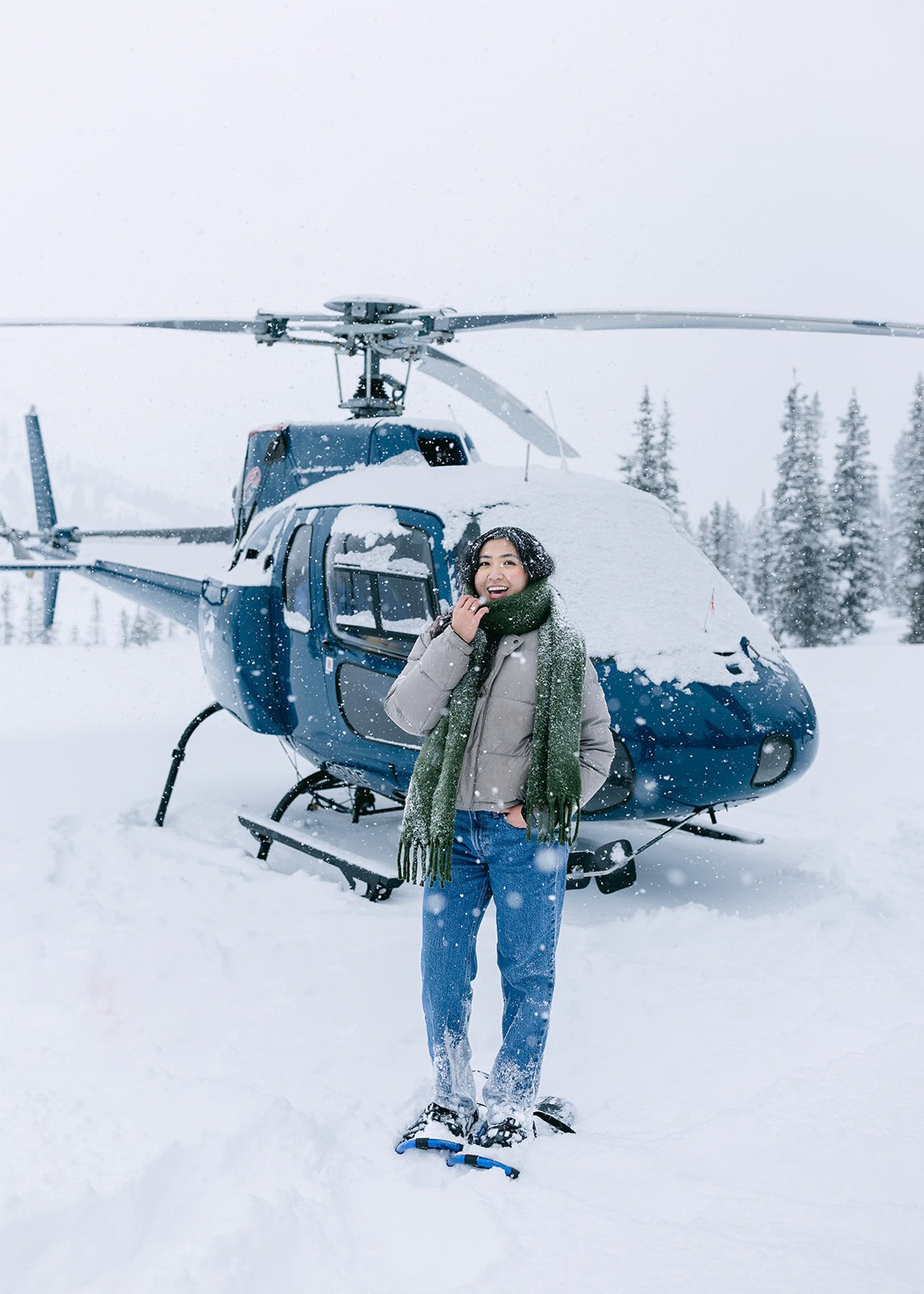 Snowy Banff helicopter proposal scene with low visibility and winter clouds covering the landscape below