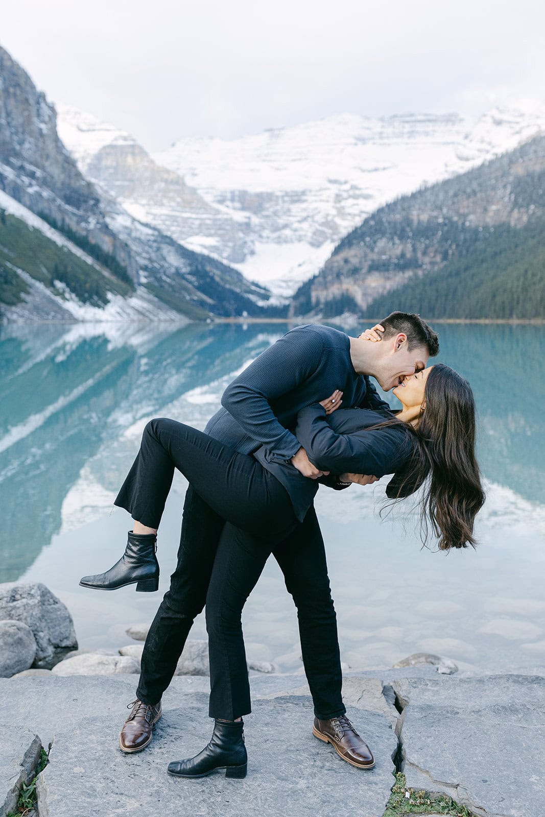 Adventure engagement session in Kananaskis with glacier-fed lake and rugged mountain scenery