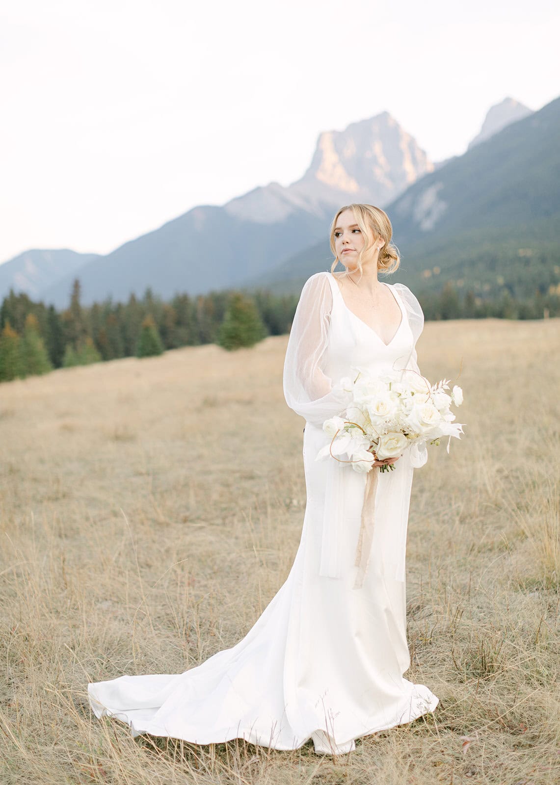Canmore elopement with couple surrounded by dramatic mountain views