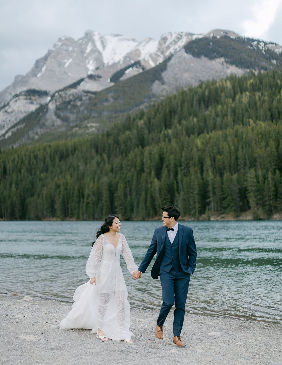 Lake Minnewanka elopement candid moments along the lakeshore