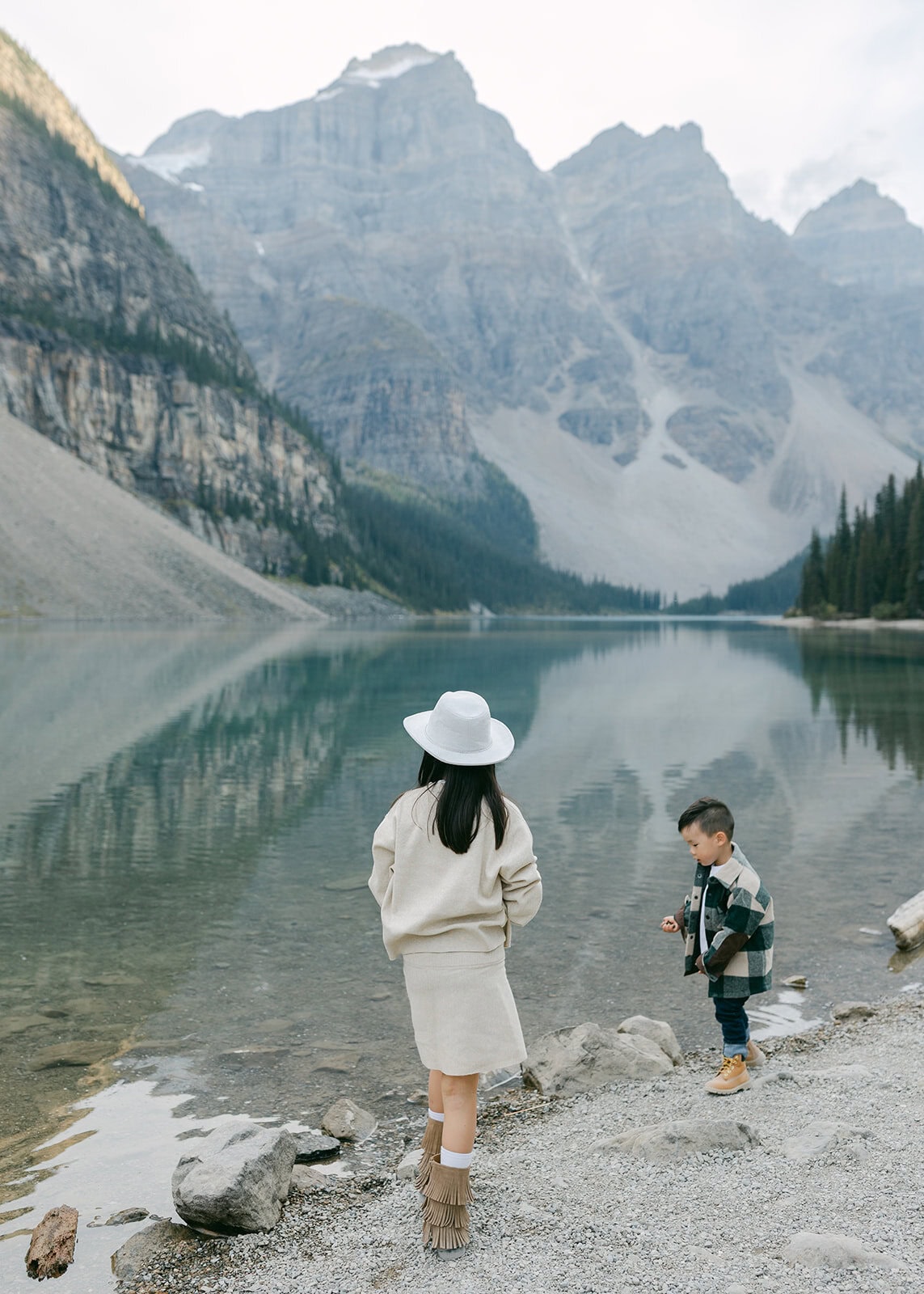 Kids exploring rocks and playing during a Banff family photographer session in the Rockies