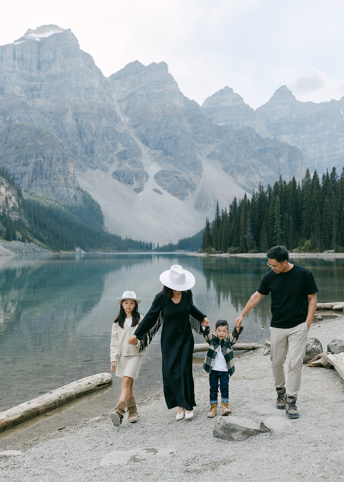 Scenic wide shot of a family session with mountains and forest in Banff