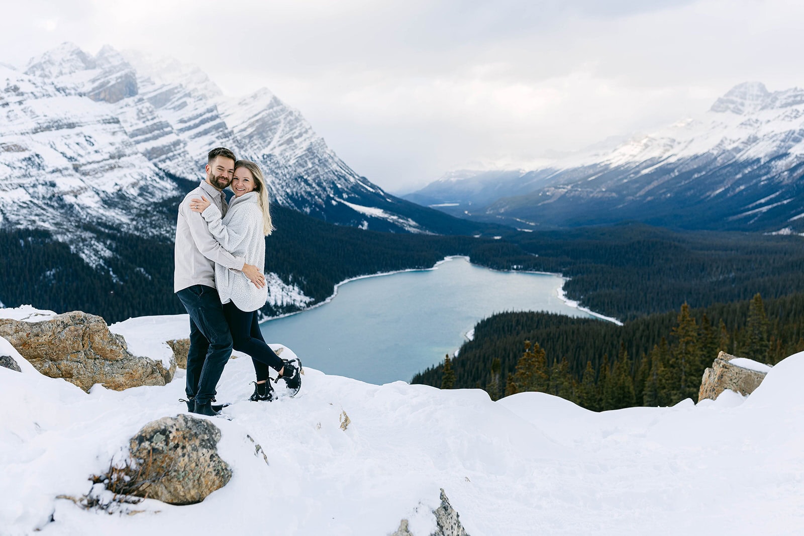 Peyto Lake engagement in winter featuring turquoise blue lake water, snowy peaks, and a romantic Banff mountain backdrop.