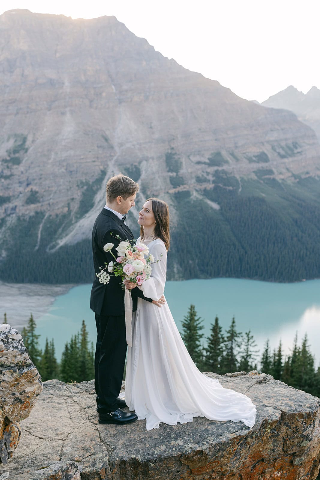 Peyto Lake elopement with bride and groom embracing above the glacial lake