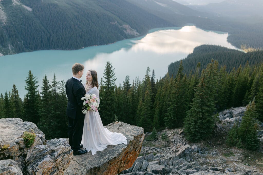 Peyto Lake elopement couple celebrating at a quiet overlook in the Rockies