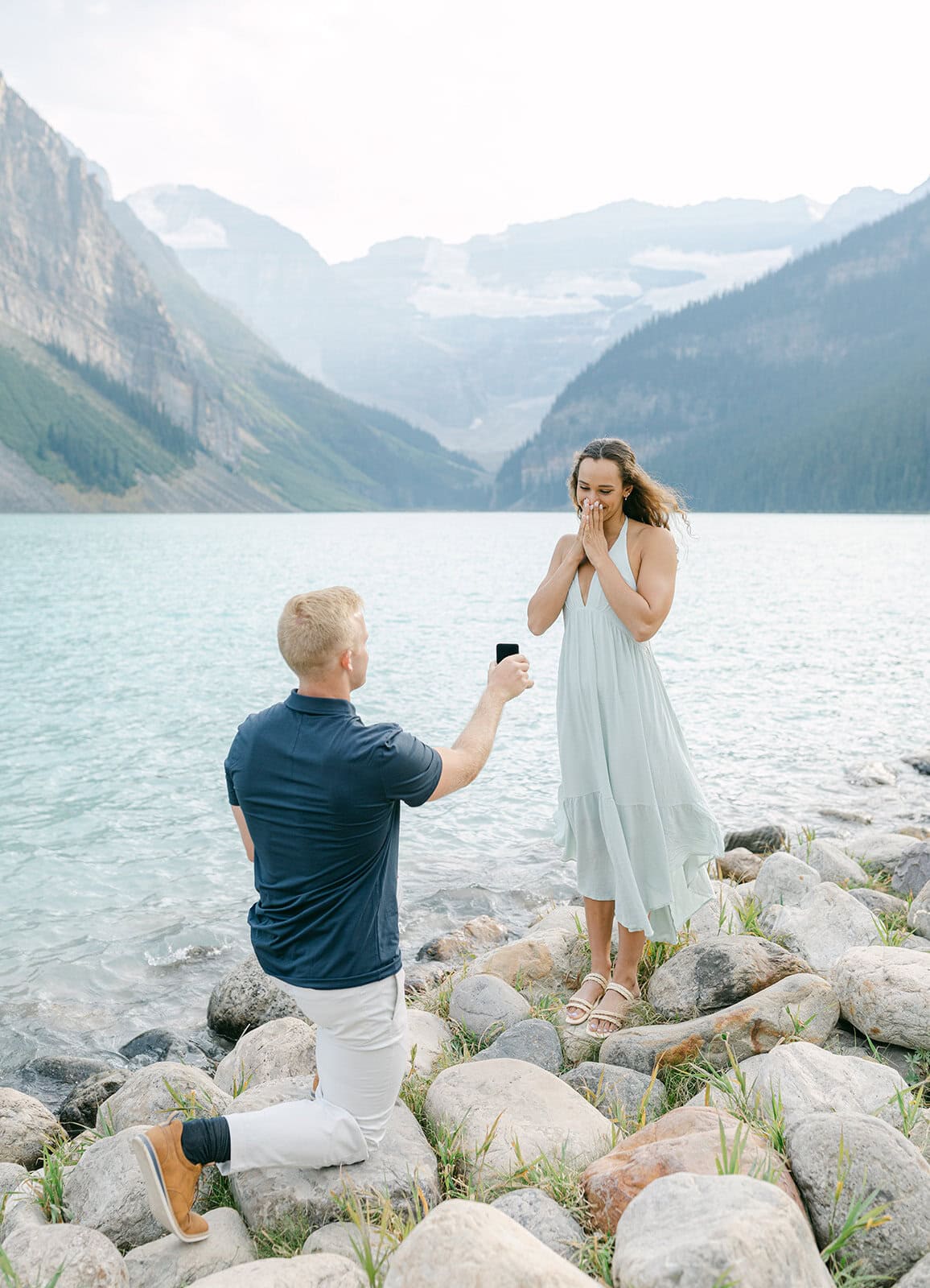 Intimate moment between couple with Victoria Glacier backdrop at Lake Louise