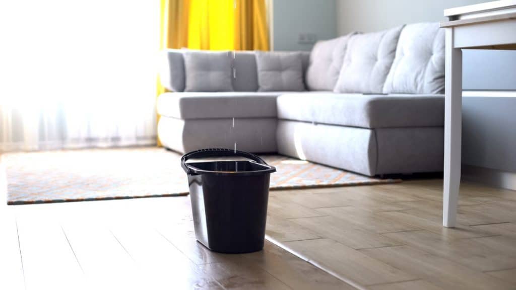 Condo water damage leaking into a bucket