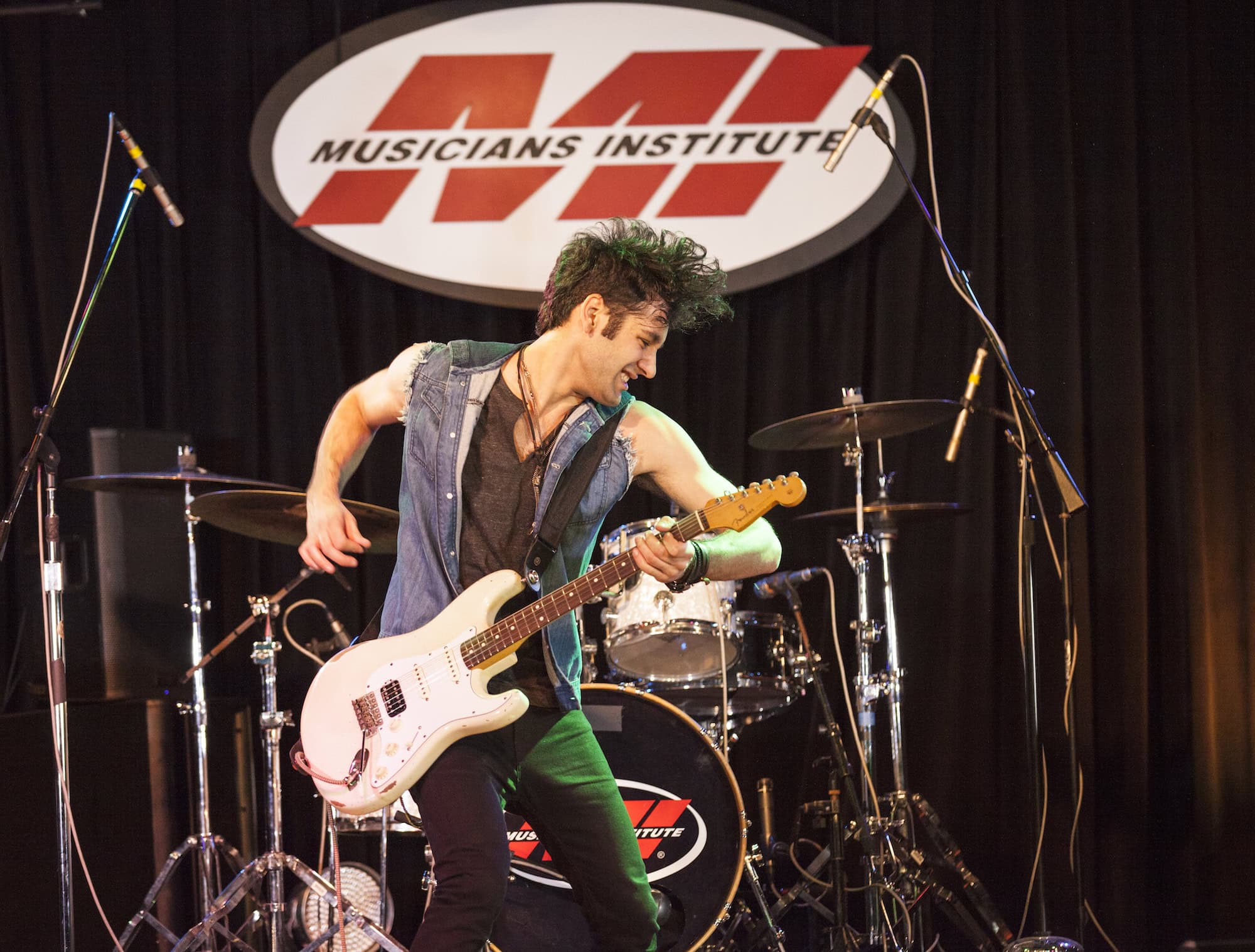 young man playing electric guitar at musicians institute