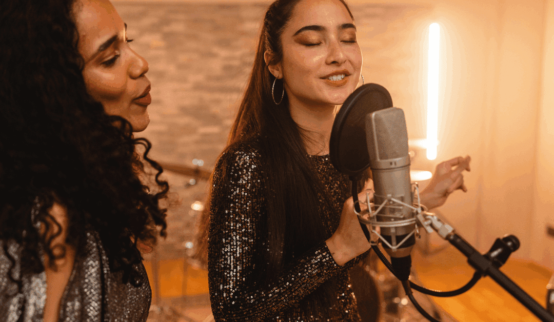 Backup singers performing live on stage in harmony