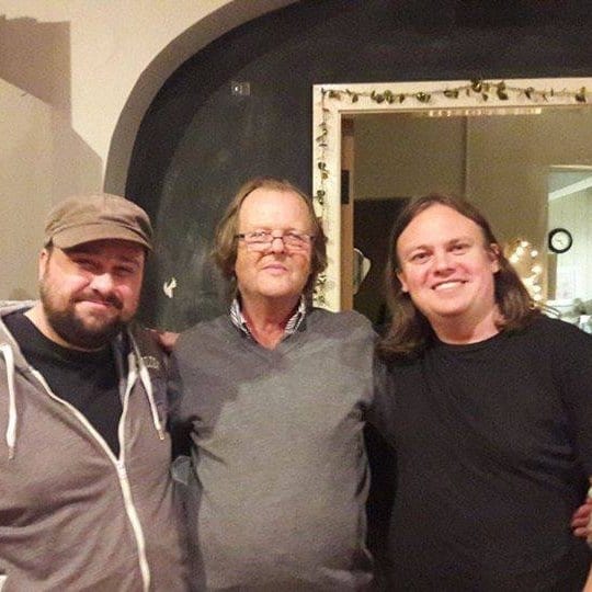 Donal Coghlan with two musicians at Musibiz event, discussing the Irish independent music scene.