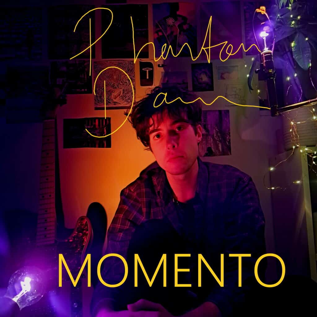 Young man with dark hair in a dimly lit room with purple and yellow lights, album titled "Momento" b.