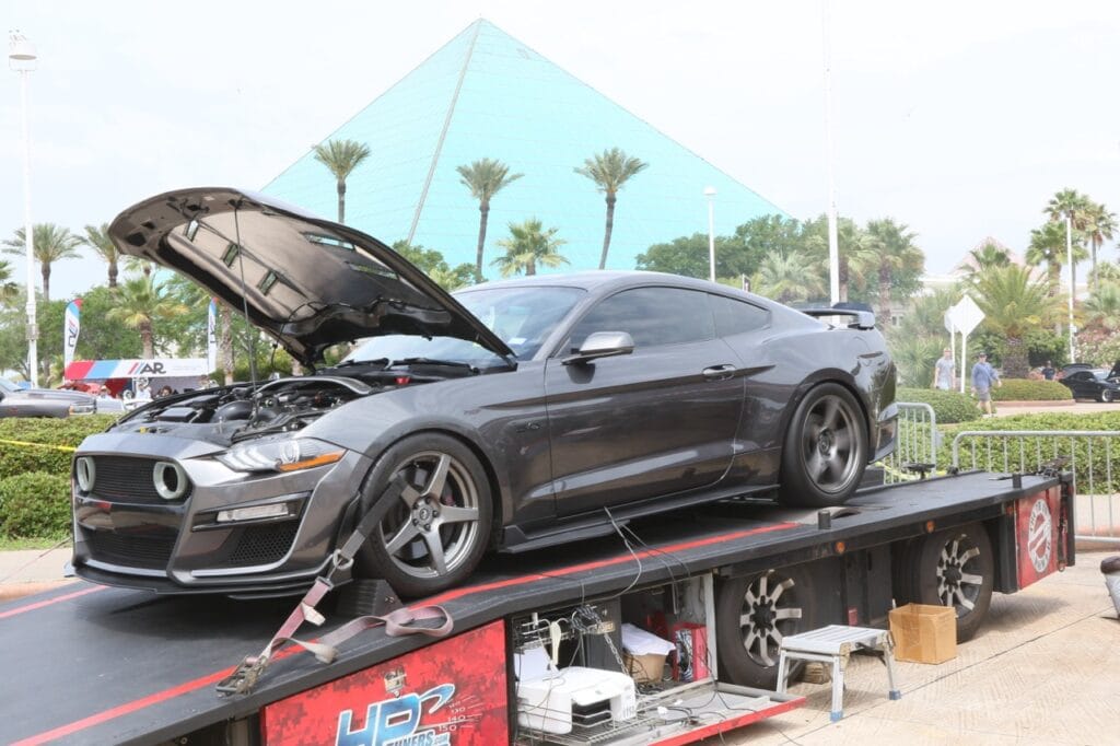 Black Ford Mustang on a platform at Mustang Week Charlotte 2026 event.