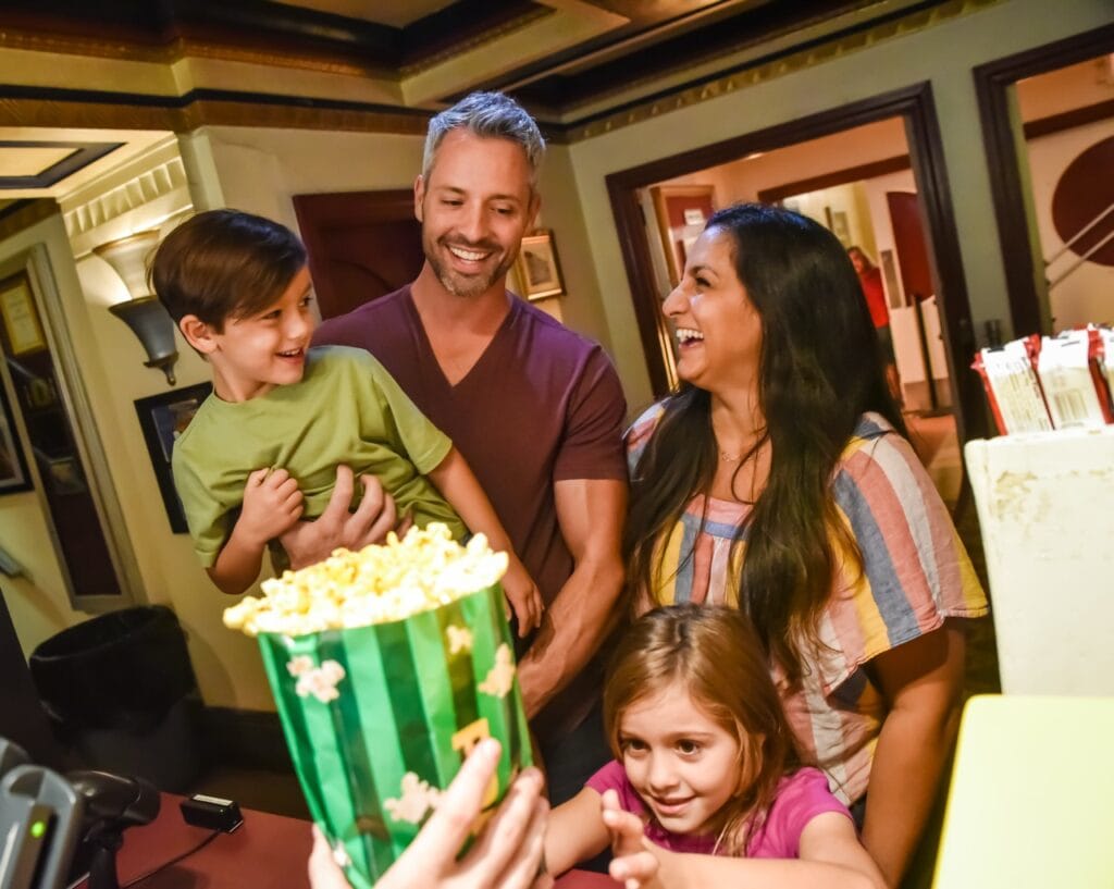Family enjoying popcorn and celebrating together at home.