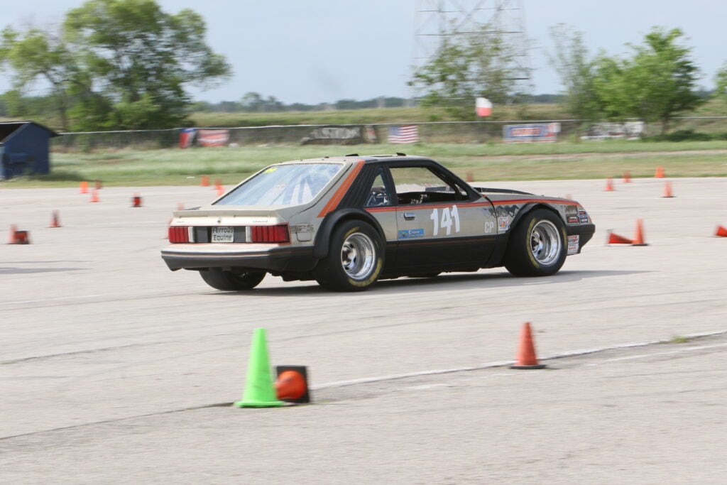 Classic Ford Mustang participating in autocross event at Mustang Week.