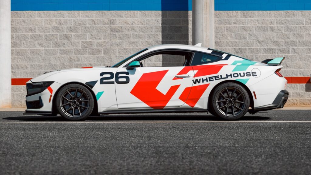 Race car with Wheelhouse Racing branding at Charlotte track.
