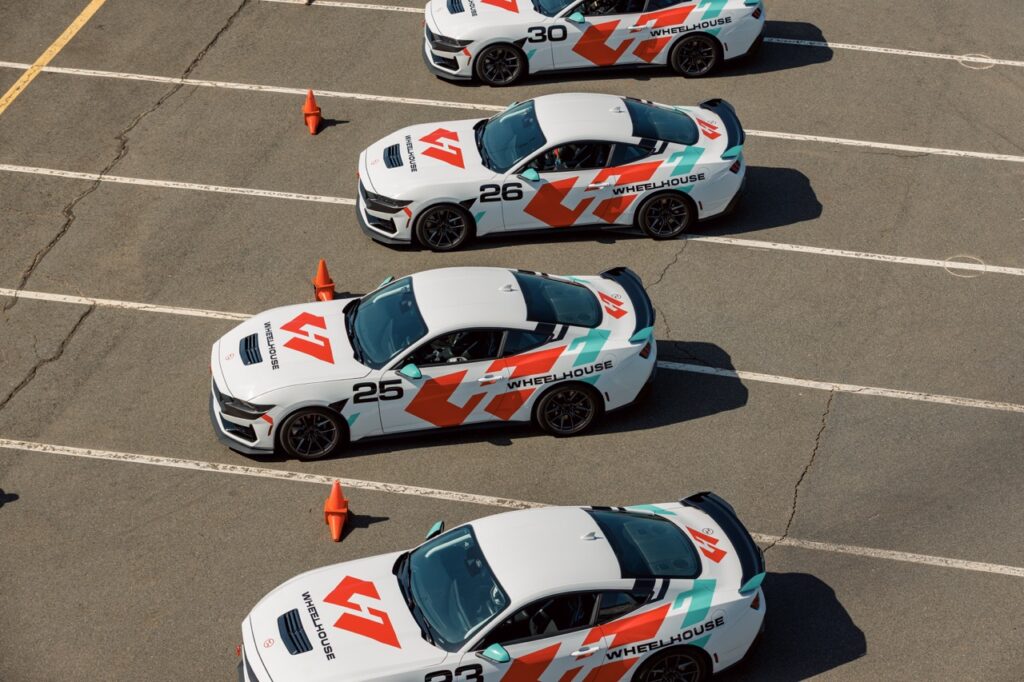 Race cars lined up at Charlotte track for Mustang Week event.