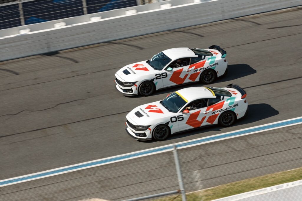 Two race cars on track during Mustang Week event in Charlotte 2026.
