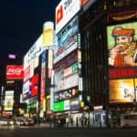 Vibrant cityscape of Susukino at night, with glowing neon signs including the iconic NIKKA whisky billboard, marking the center of Sapporo’s nightlife and izakaya culture.