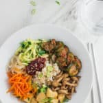 Korean vegan bibimbap bowl with rice, sautéed vegetables, tofu, and gochujang sauce