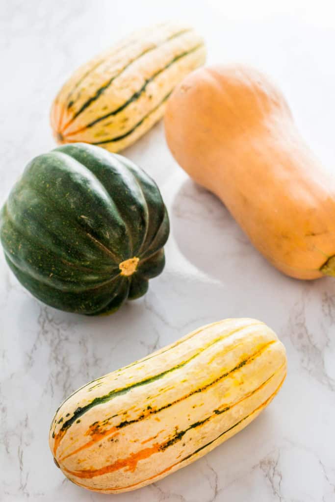 A photo of acorn, butternut, and delicata sqush