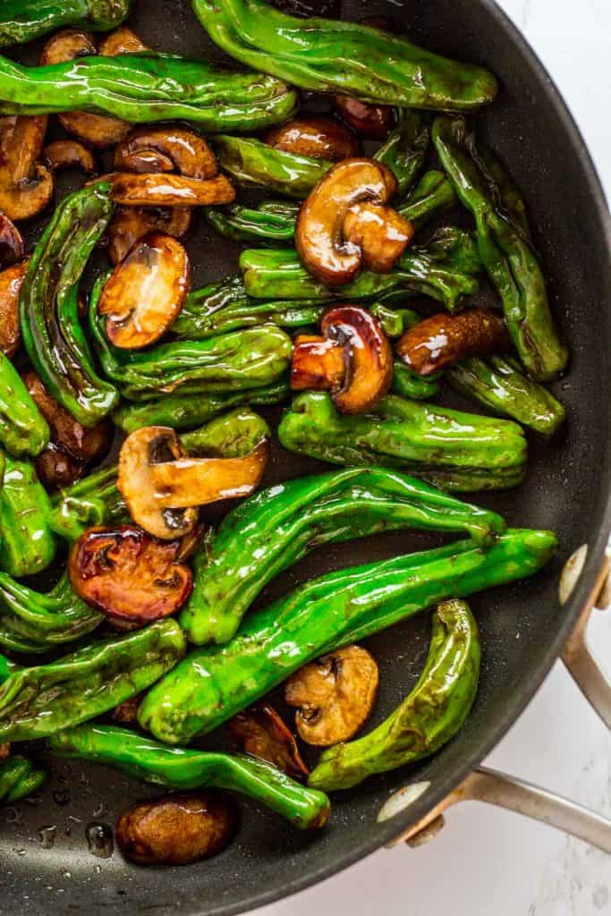 Shishito pepper and mushroom stir fry in the pan