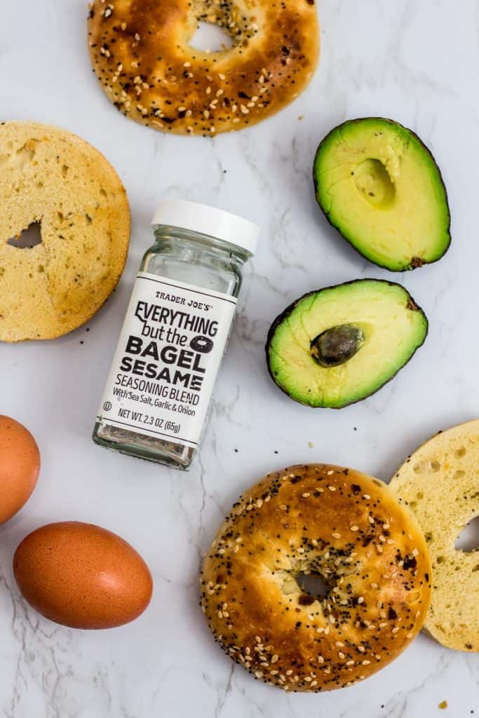 ingredients to make sandwich - bagel, avocado, egg, and everything bagel sesame seasoning