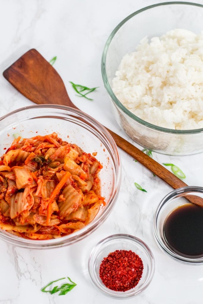 Ingredients to make kimchi fried rice - rice, kimchi, red pepper flakes, soy sauce