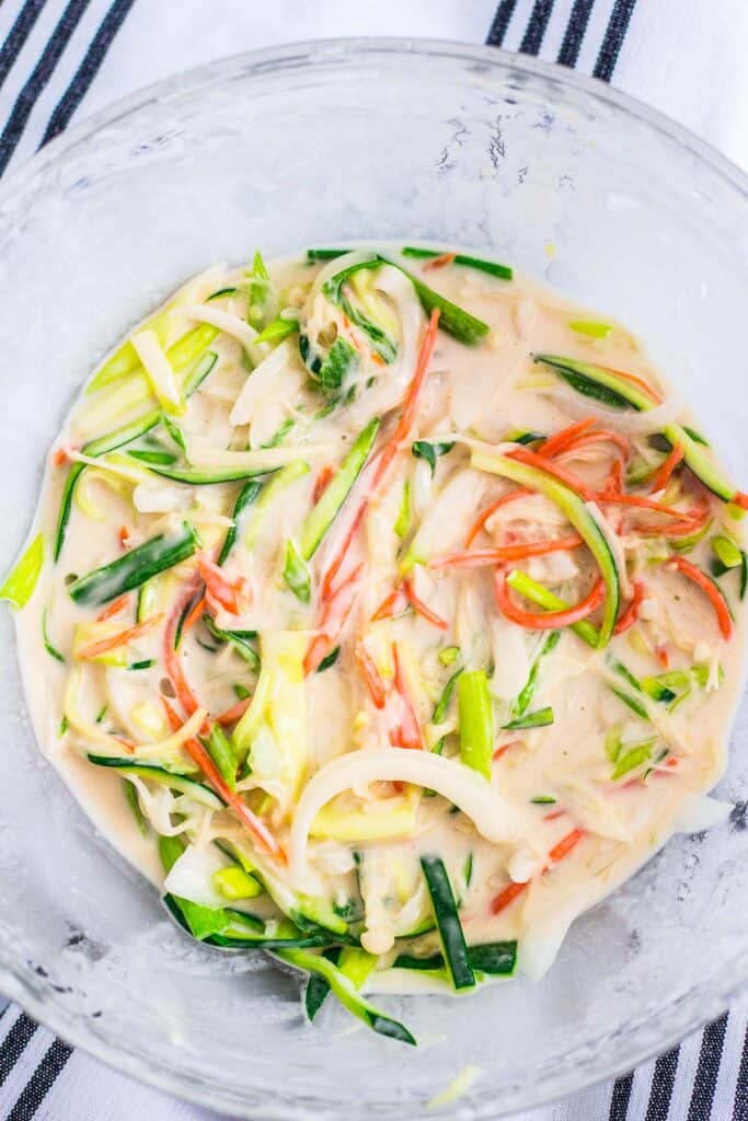 Thinly sliced vegetables coated in batter for making vegan Korean vegetable pancakes.