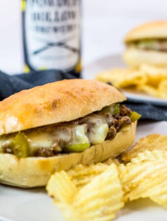 Vegetarian Philly cheesesteak sandwich made with Impossible meat, melted provolone, onions, and green bell peppers