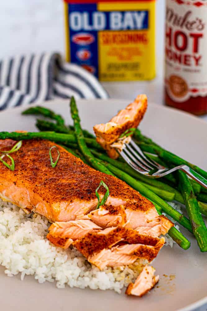 Flaky salmon fillet with Old Bay and hot honey, served with rice and asparagus