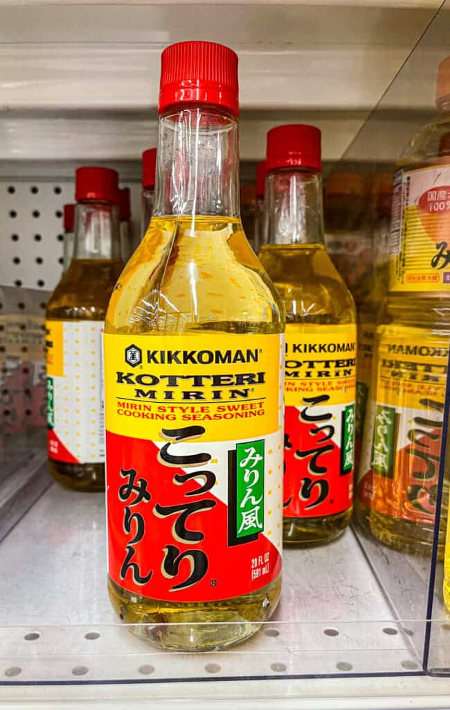 Close-up of a bottle of Kikkoman Kotteri Mirin, a sweet mirin-style cooking seasoning, on a grocery store shelf.