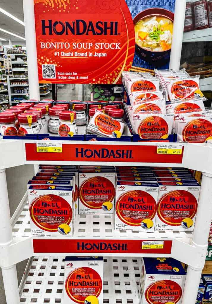 Display of Ajinomoto Hondashi bonito soup stock at a grocery store, a popular dashi seasoning used in Japanese soups and broths.