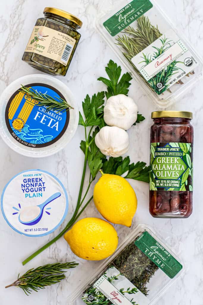 Mediterranean ingredients list featuring feta, Greek yogurt, capers, kalamata olives, garlic, lemon, and fresh herbs like rosemary and thyme