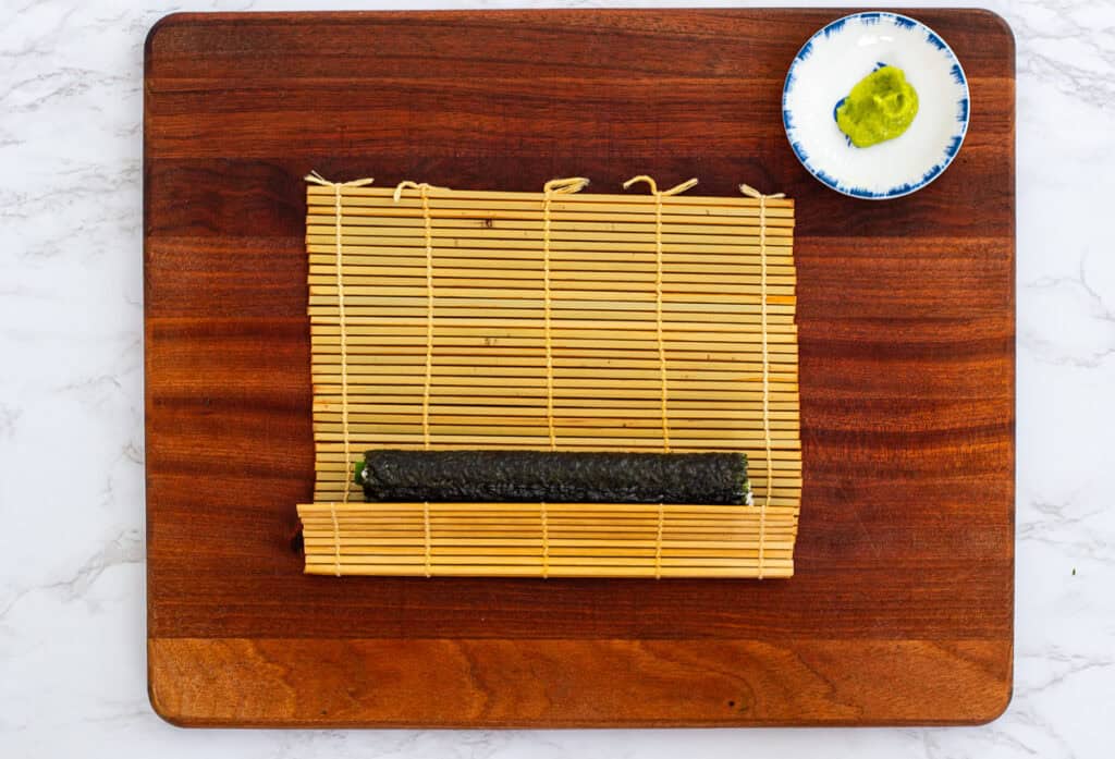 Sushi roll wrapped in bamboo mat for rolling hosomaki