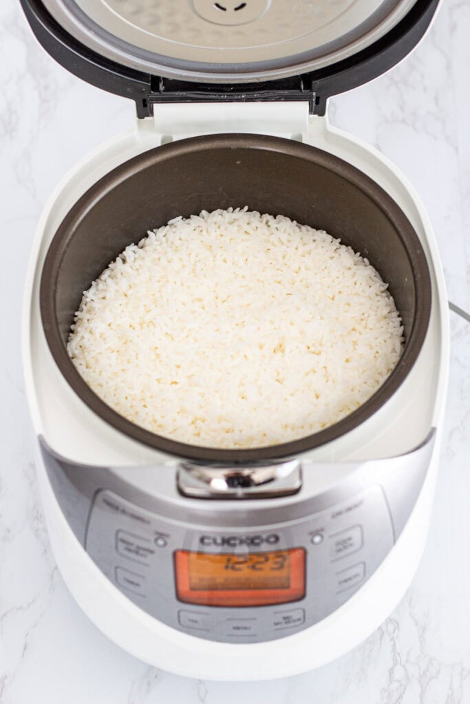 Freshly cooked short-grain sushi rice in a Cuckoo rice cooker, ready for seasoning