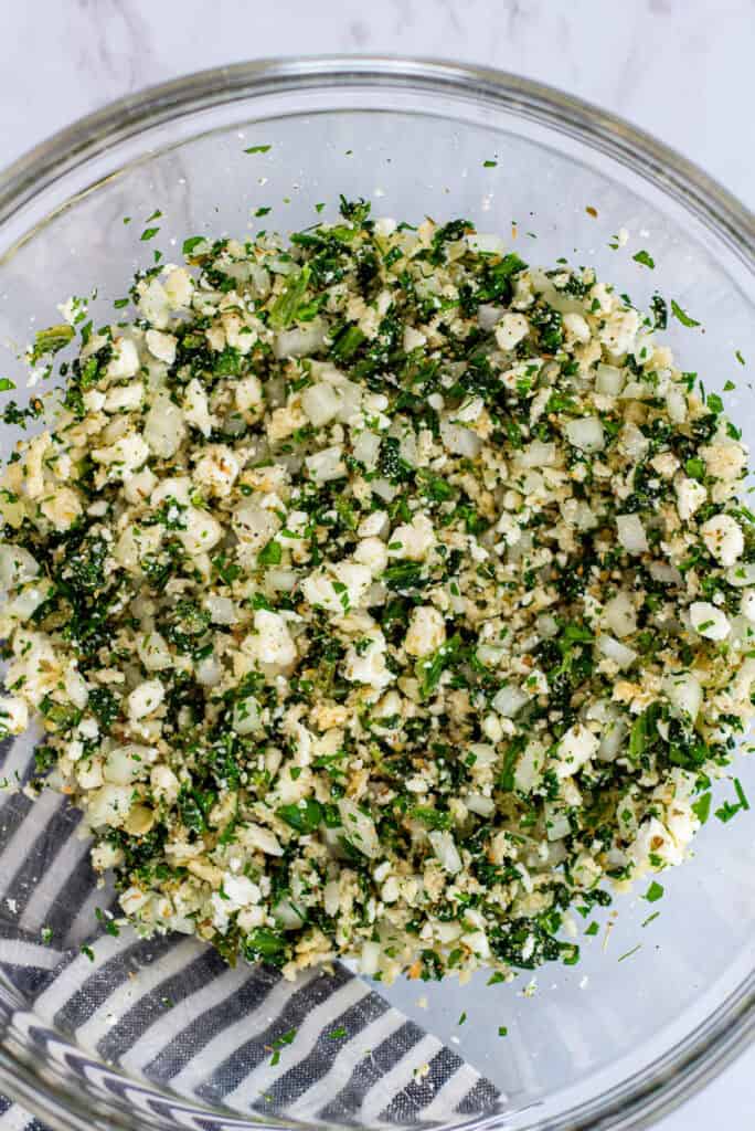 Mixture of spinach, feta, onion, herbs, and breadcrumbs for Greek chicken meatball recipe