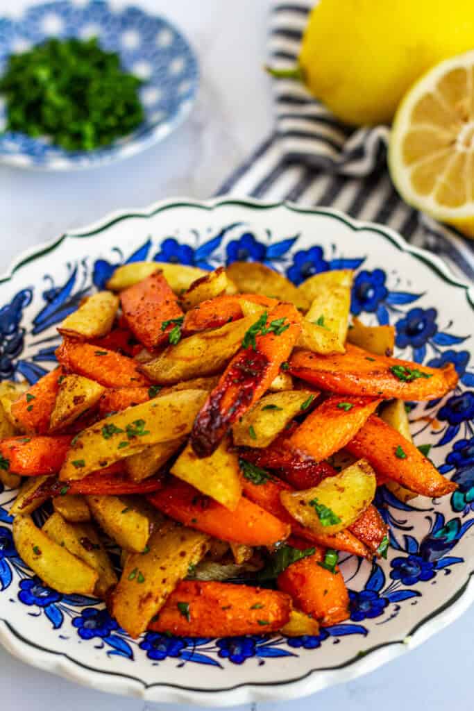 Close-up of Moroccan roasted carrots and parsnips garnished with parsley
