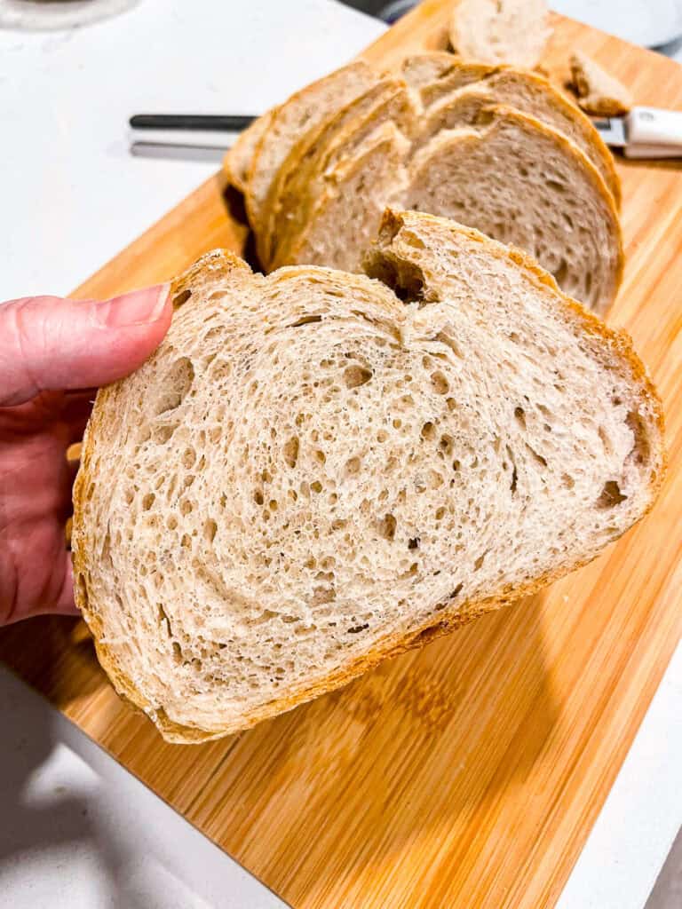 Slice of sourdough discard bread with an even crumb and soft texture, showing what a sourdough beginner can bake using leftover starter.