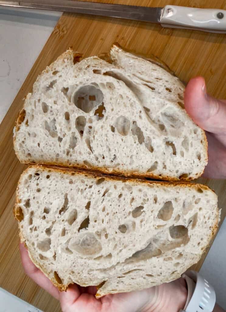 Slice of sourdough bread with an even, open crumb, showing how technique improves as a sourdough beginner gains experience.