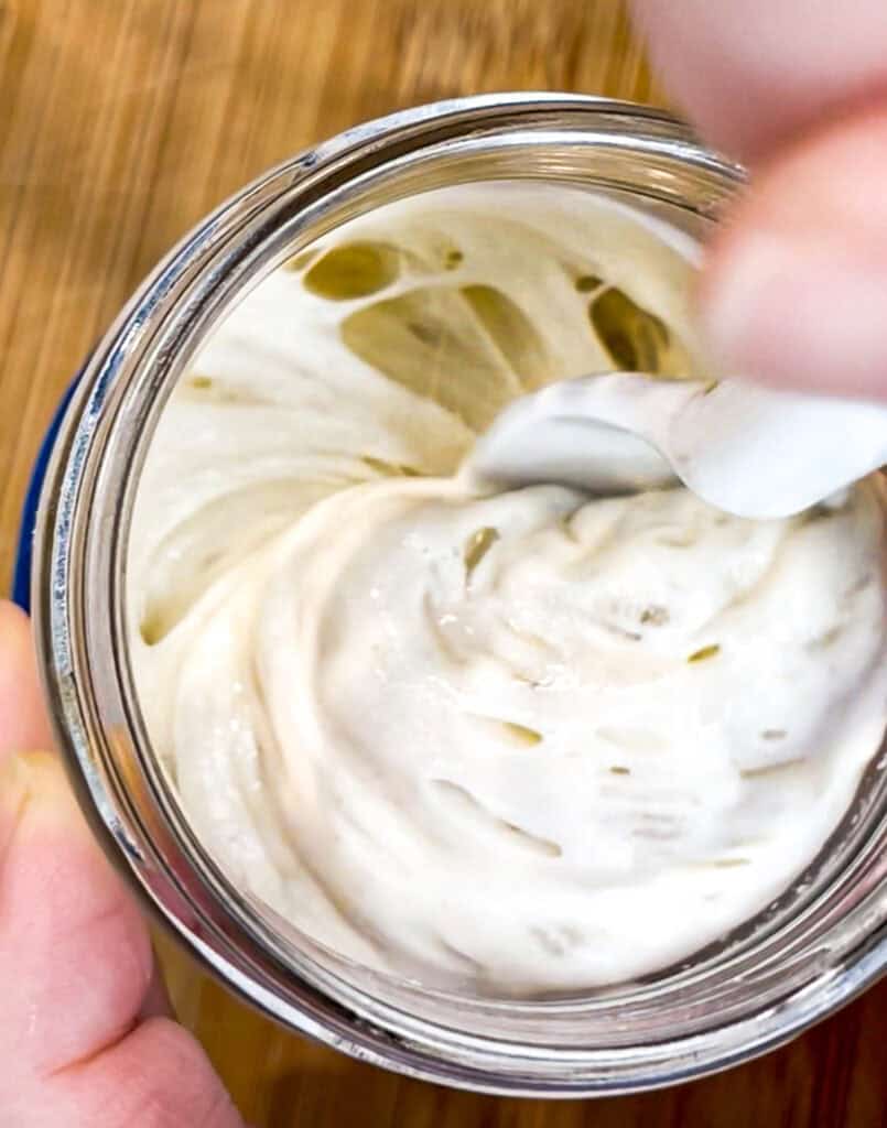 Close-up of a bubbly, active sourdough starter in a glass jar — the kind of healthy starter I learned from as a sourdough beginner.